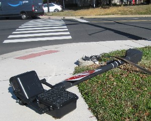 Pedestrian signal lying on sidewalk